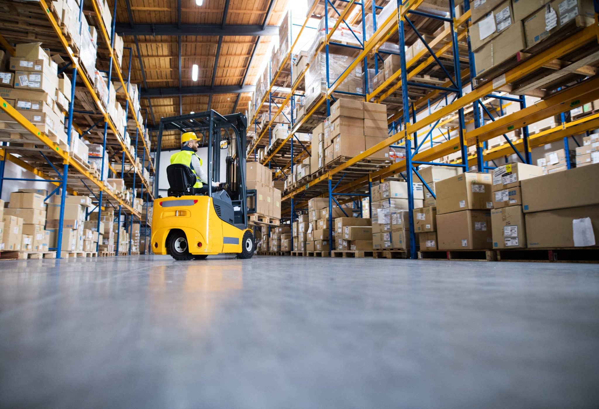 a worker utilizing material handling equipment